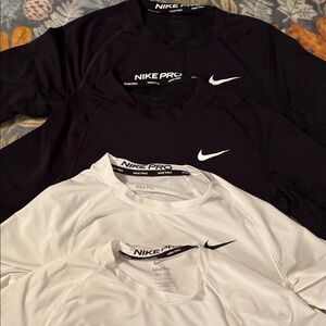 Nike Pro Black (2) and White (2) Short Sleeve Slim Fit Tops. Size men’s small.